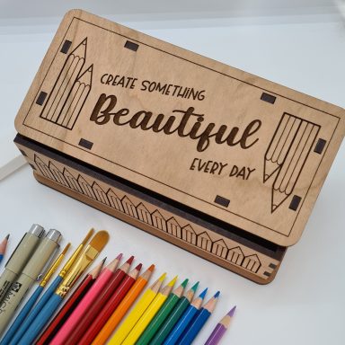 A wooden engraved pencil box